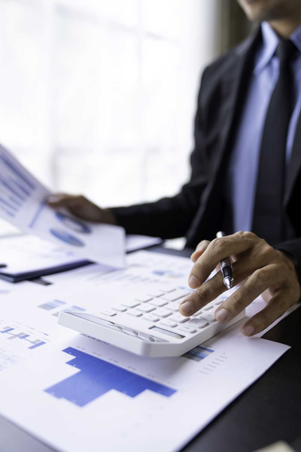 asian-male-finance-staff-is-calculating-by-using-a-2023-11-27-05-20-18-utc